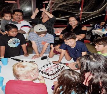 Kids gathered around a table for their party
